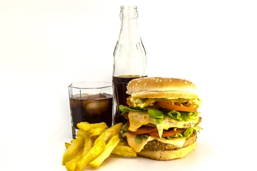 Double meat and cheese burger with fresh fries and a coke on a white background