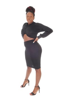 A beautiful young tall African American female standing in a tight.gray dress, showing her figure, isolated for white background.