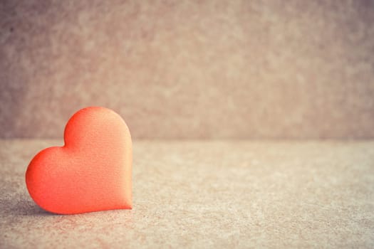 Red heart on the wooden desk background. Copyspace