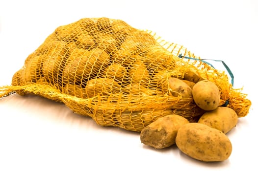 Ripe potatoes in burlap sack isolated on white background