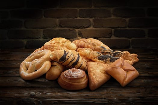 Mixed sweet and salted pastry, patisserie, bakery products on rustic background