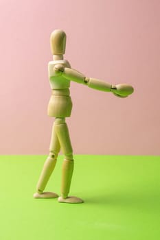 The figure of a wooden man stretches his arms forward, he wants to hug someone. The concept of loneliness, the need for attention. Close-up