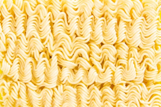 Instant noodles. Asian fast food on a yellow background close-up. Top views macro photography.