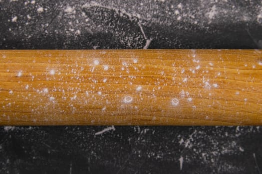 Baking desk with flour and rolling pin, top view.
