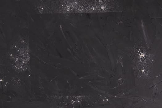 White flour on slate background. Top views