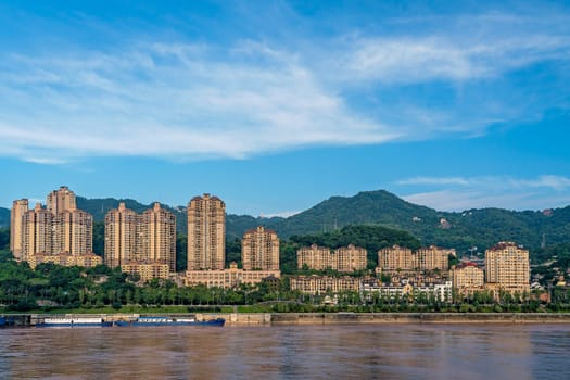 Chongqing, China -  August 2019 : Highrise residential and commercial buildings on the shore of Yangtze river in Chongqing city
