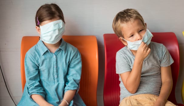 Kids wearing facial disposable mask to avoid viral infection. Virus protection