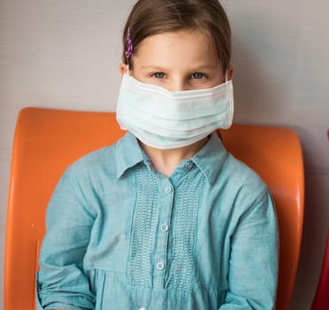 Girl wearing facial disposable mask to avoid viral infection. Virus protection