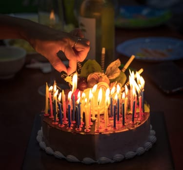 Birthday cake with candles in dark