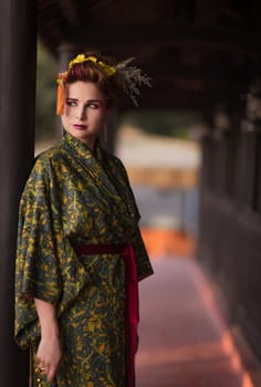 Fine art portrait of beautiful woman in Japanese Geisha style wearing kimono
