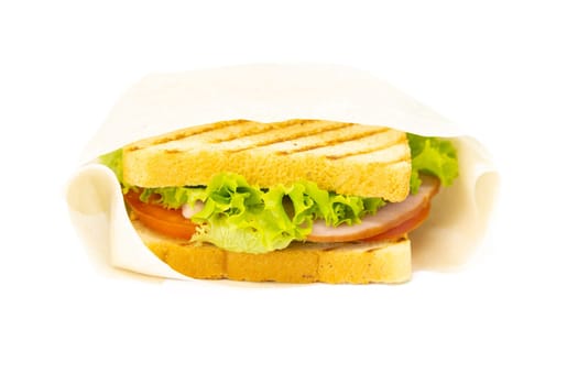 Sandwich with ham, cheese, tomatoes, lettuce, and toasted bread. Front view isolated on white background.