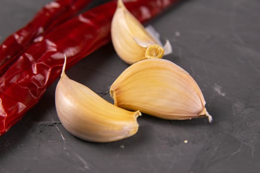 Red hot chili peppers and garlic, isolated on black.