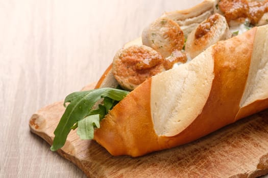 Lye roll with fried veal sausage, angula and sweet mustard