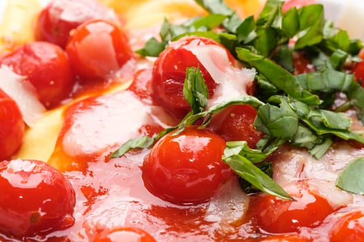 Red cherry tomato sauce with basil as close-up