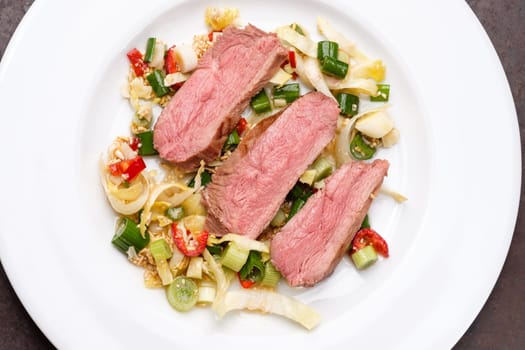 Duck breast sous vide and roasted on rice chili and spring oinions