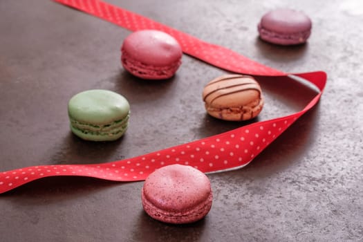 Macaron on a griddle with red ribbon