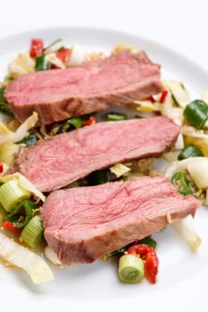 Duck breast sous vide on asian vegetable and rice in vertical format