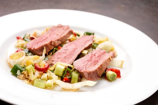 Sous vide roasted duck breeast on asian vegetable and rice