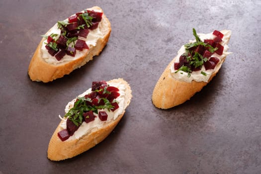Bruschetta slice of breat with farmers cheese parsley and beetroot