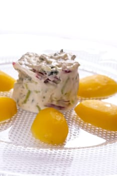 Potatoes and curd on glass plate in vertical format