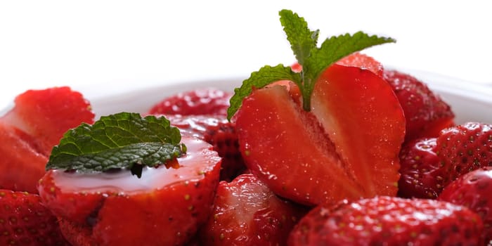 Red strawberries with green mint leaf as close-up