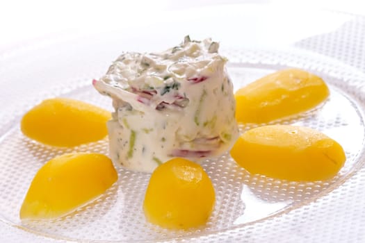 Potatoes with curd radish and cucumber in back lit