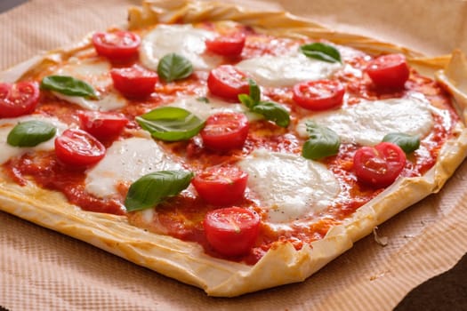 Pizza with tomato mozzarella cheese basil on filou pastry