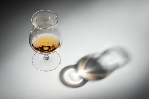 Glass of whisky with shadow hovering in the air