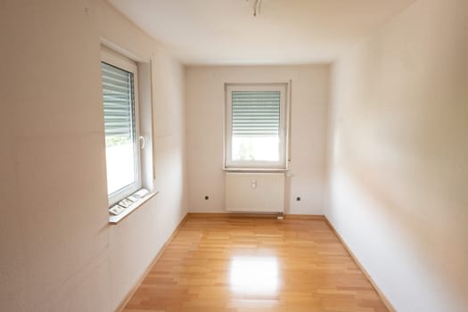 Empty room with window and parquet in back lit
