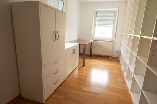 Office room with white rack cupboard and desk