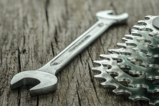 Wrench and sprocket for biycicle on wooden board