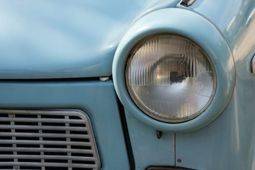 Headlight anf front of a trabant in blue as close-up