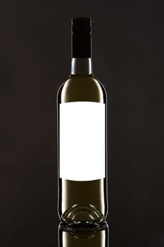 White wine bottle on black with label blank for text
