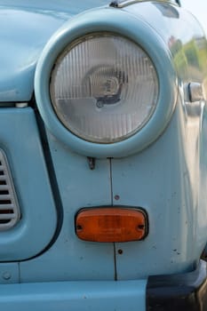 Blue trabant car headlight in vertical format
