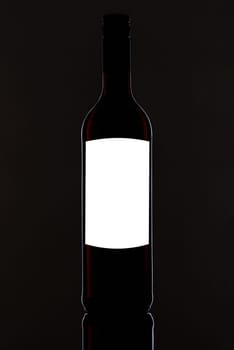 Black red wine bottle with white blank label for text and graphic