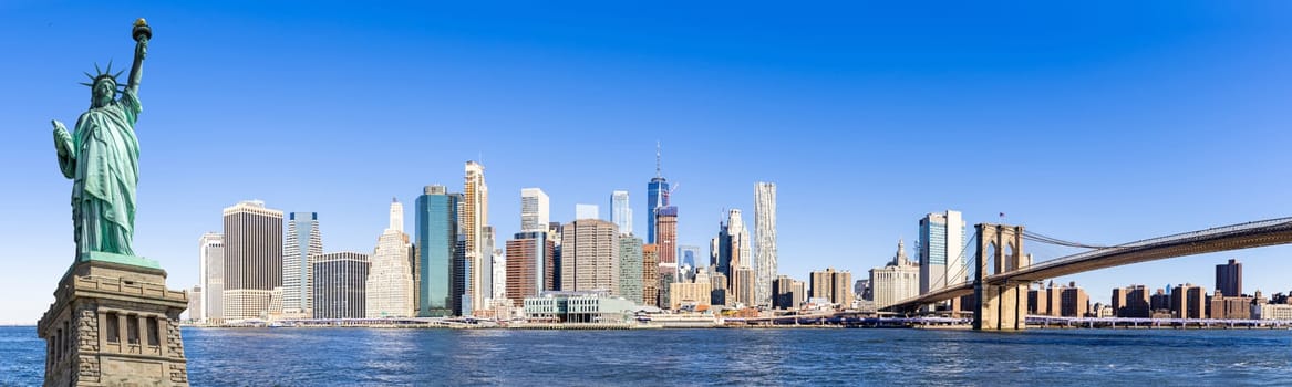 Panorama statue of liberty Landmark of New York with view of New York city Lower Manhattan skyscraper skyline building cityscape from Brooklyn New York State USA.