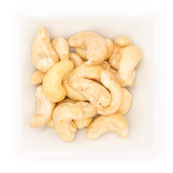 Cashew nut in a white square bowl in top view