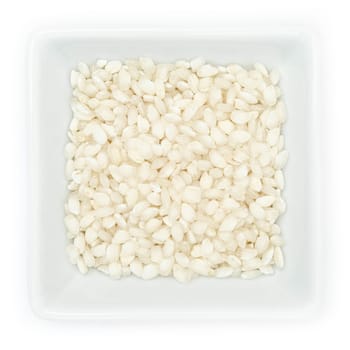 Italian rice risotto Vialone Nano in white bowl in top view