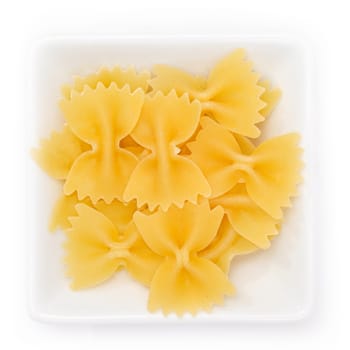 Farfalle pasta noodles in a white bowl in top view