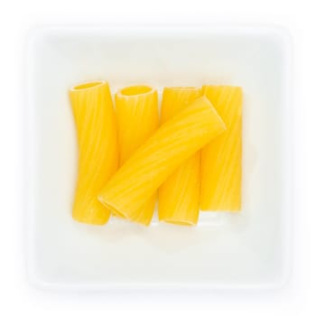 Pasta tortigoni raw in a white bowl in top view