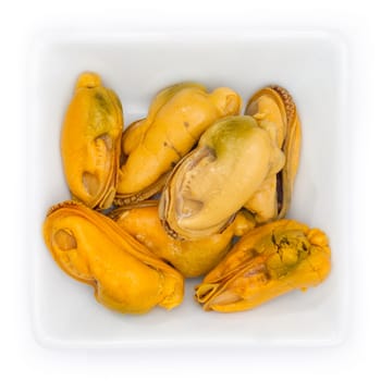 Mussel flesh in a white bowl in top view