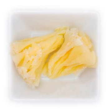 Tete de moine cheese as rosette in a bowl in top view