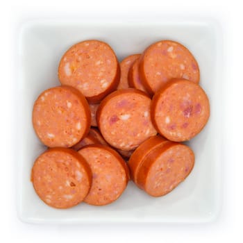 Debreziner sausage in slices in a bowl in top view