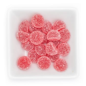 Red gum drops with pomegranate aroma in a bowl in top view