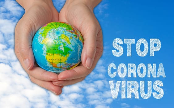 Female hands with globe, stop corona virus