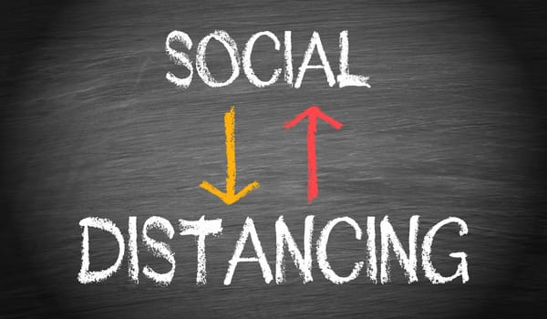 Social Distancing, coronavirus disease prevention concept on blackboard or chalkboard