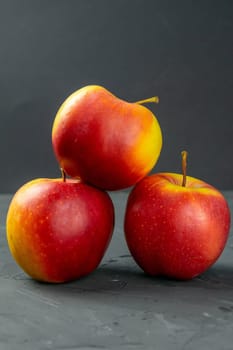 Apples on black stone table background. Front views
