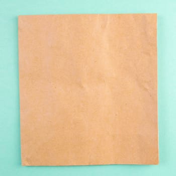 A sheet of craft paper on a mint background.