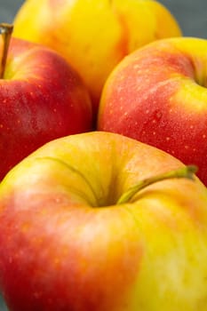 Apples on black stone table background. Front views, macro photography, close-up.