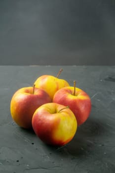 Apples on black stone table background. Front views